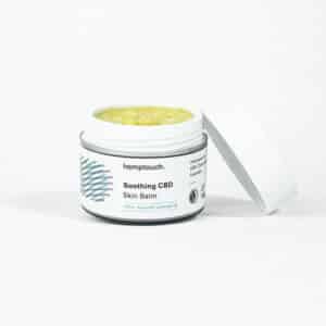 Place an open jar of Hemptouch calming CBD-balm (50 ml/50 mg) with the label visible, next to its detached lid, on a plain white background.