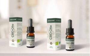 three bottles of cbd oil on a table.