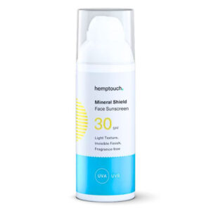 A bottle of Hemptouch - Mineral Shield Face Sunscreen SPF 30 (50ml), labeled as light texture, invisible finish, and fragrance-free. The bottle is white with blue accents and a clear cap.